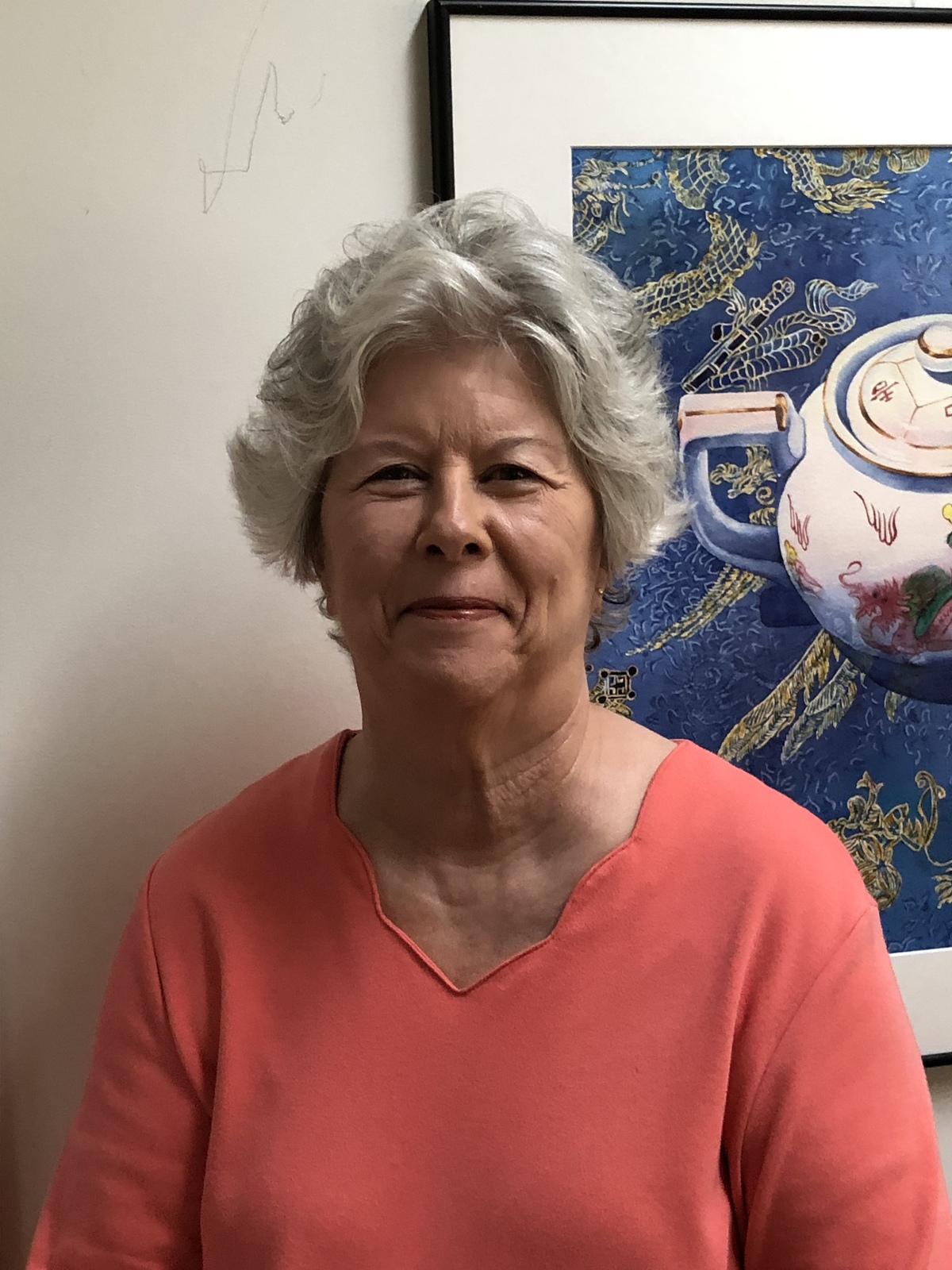 Deb Ward standing in front of her artwork